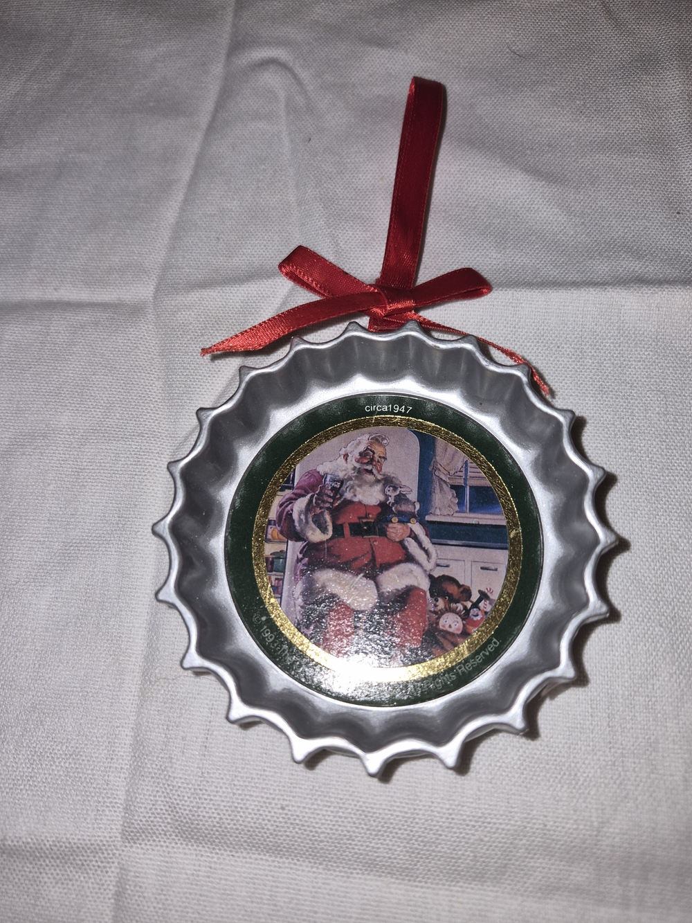 Coca-Cola Co. Holiday Santa Bottle Cap Ornament with Red Ribbon